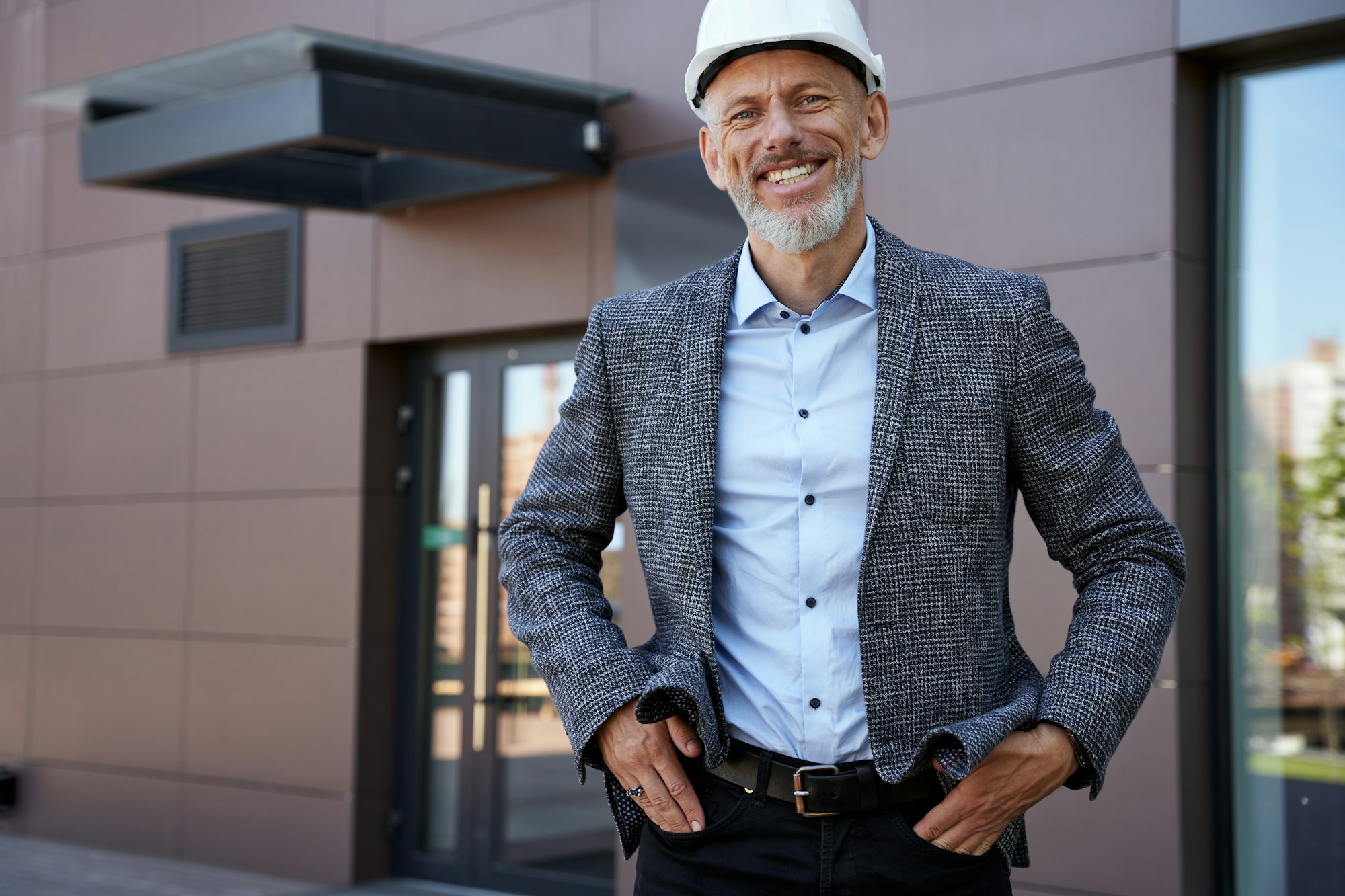Creative and Successful. Happy mature architect, engineer manager wearing helmet smiling at camera